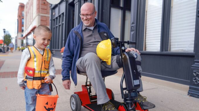 an older man and a young boy on a scooter